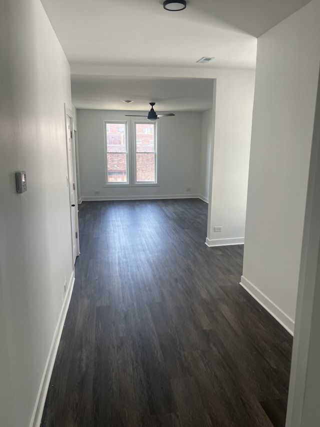 unfurnished room featuring ceiling fan and dark hardwood / wood-style floors