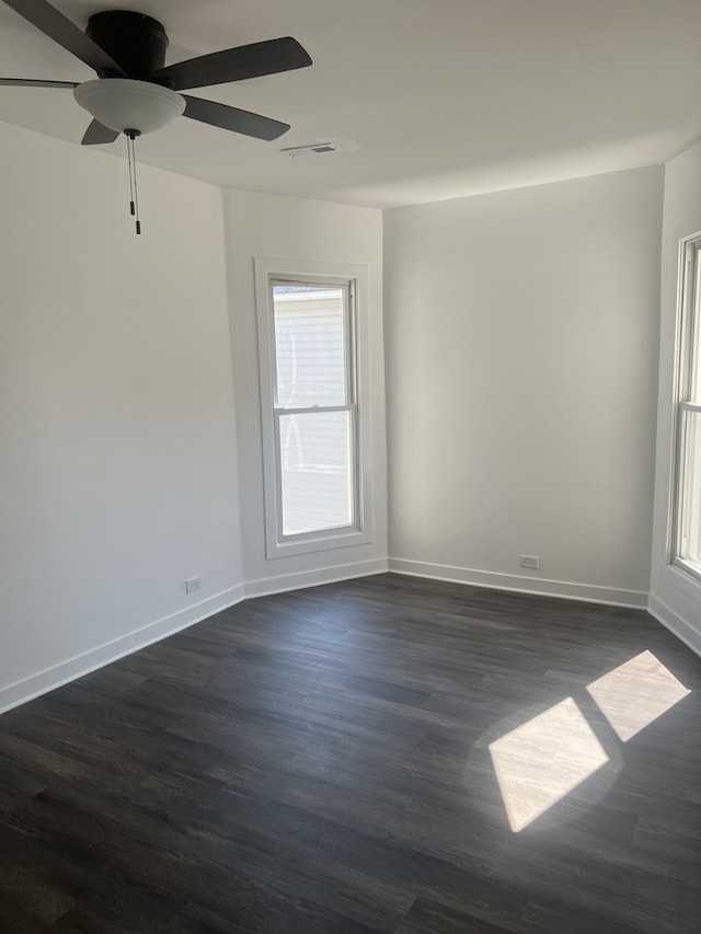 unfurnished room featuring ceiling fan and dark hardwood / wood-style flooring