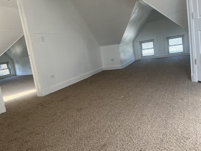 bonus room with lofted ceiling, plenty of natural light, and carpet