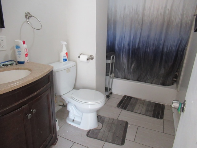 full bathroom featuring vanity, tile patterned flooring, and toilet