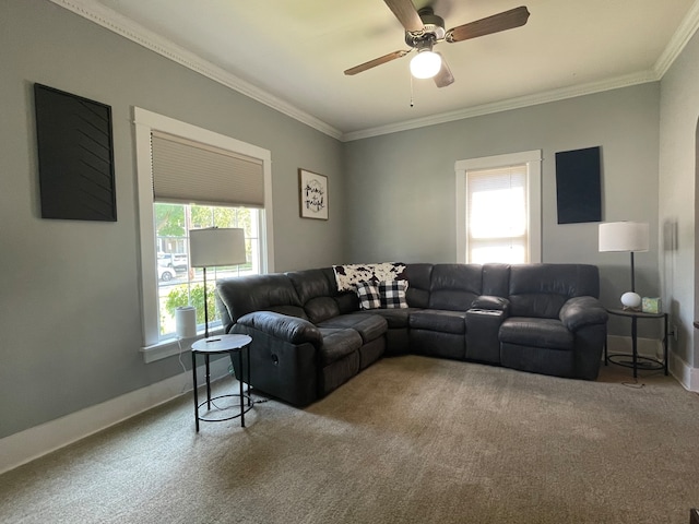 carpeted living room with ceiling fan and ornamental molding