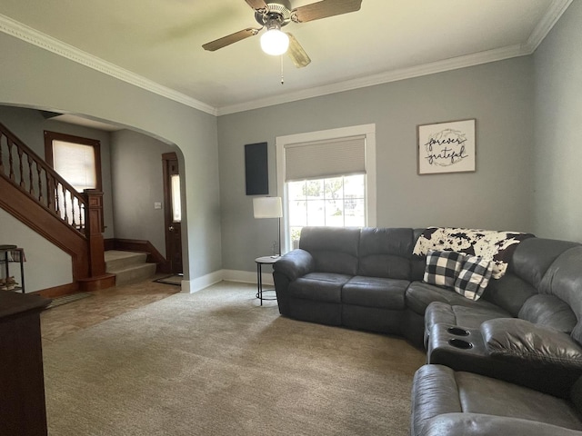 living area with ornamental molding, arched walkways, stairway, and baseboards