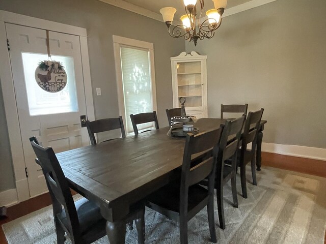 dining space featuring ornamental molding and a chandelier