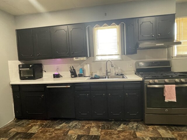 kitchen with sink, dark tile patterned flooring, backsplash, and gas stove