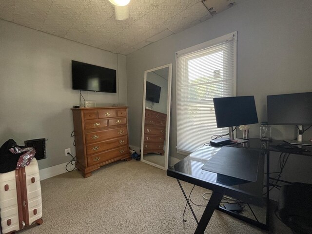 carpeted home office featuring baseboards