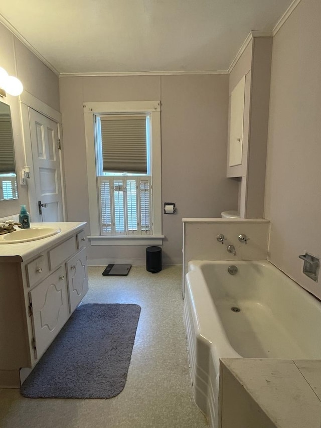 full bath featuring a bath, vanity, and crown molding