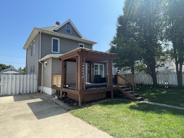 view of front of house with a chimney, fence, a front lawn, and a pergola