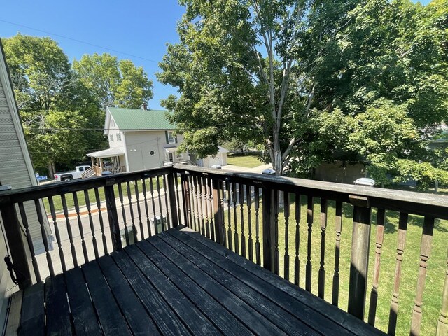 wooden terrace featuring a yard