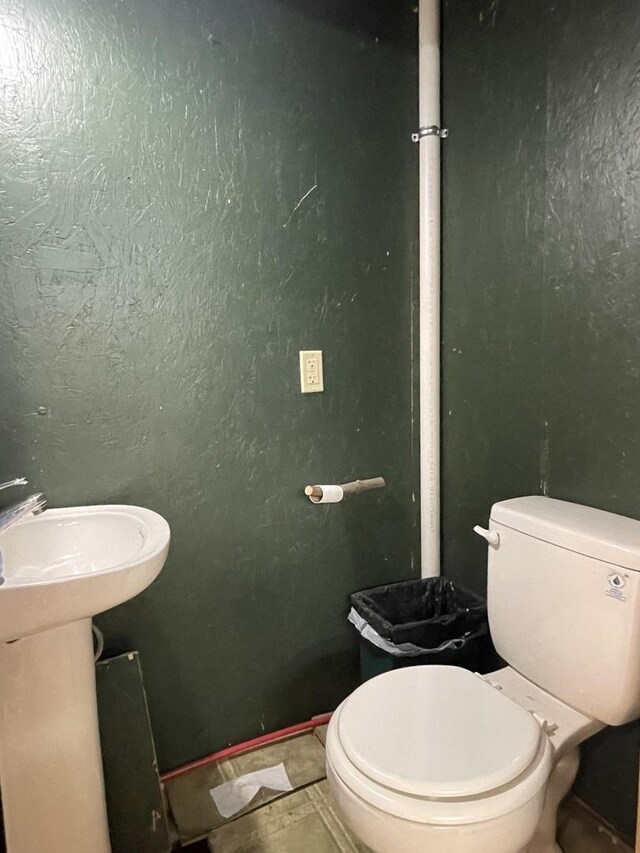 bathroom with tile patterned flooring and toilet