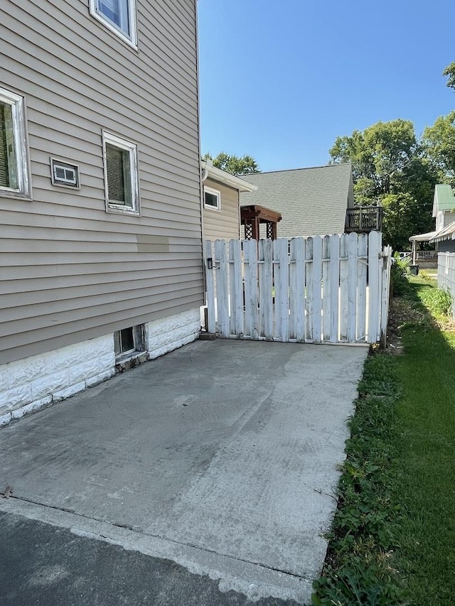 view of side of property featuring fence