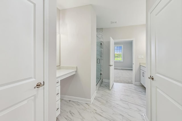 bathroom with tile patterned floors, a shower with door, and vanity