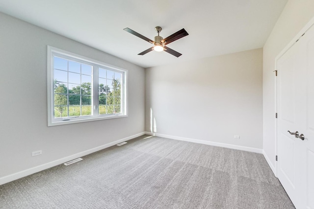 carpeted empty room with ceiling fan