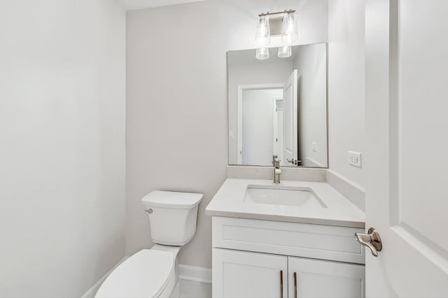 bathroom featuring toilet and vanity