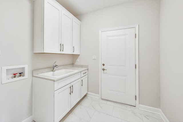 laundry room featuring sink, washer hookup, light tile patterned floors, and cabinets