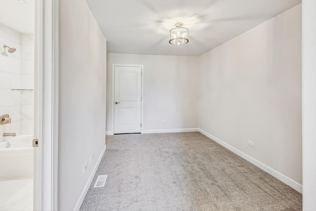 unfurnished room with light carpet