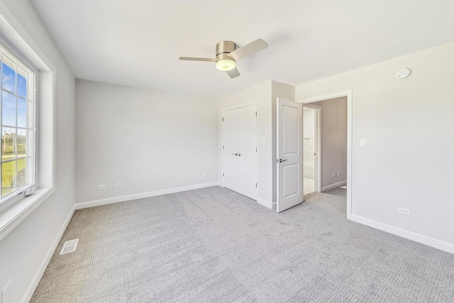 interior space with ceiling fan