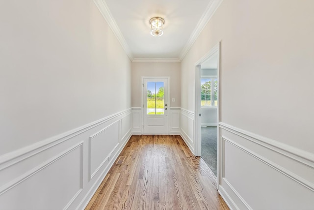 entryway with light hardwood / wood-style floors and ornamental molding