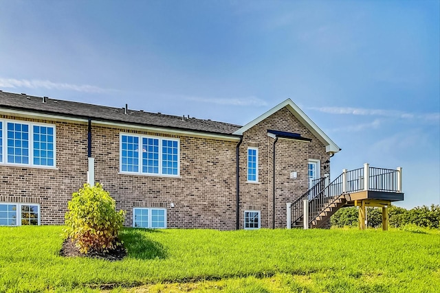 rear view of house featuring a yard and a wooden deck