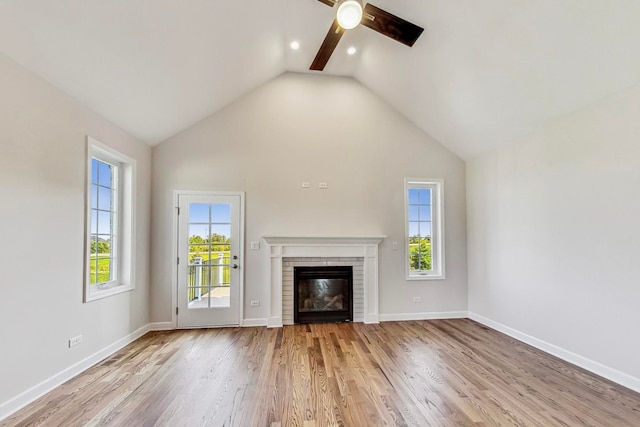 unfurnished living room featuring a fireplace, light hardwood / wood-style flooring, and ceiling fan