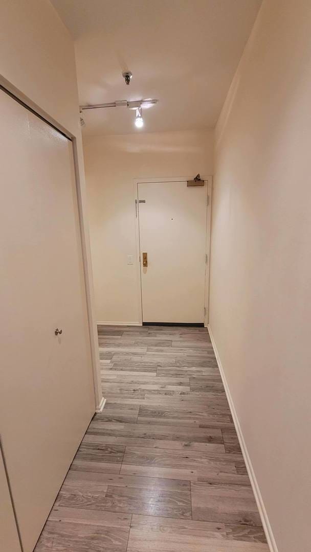 corridor with light hardwood / wood-style floors