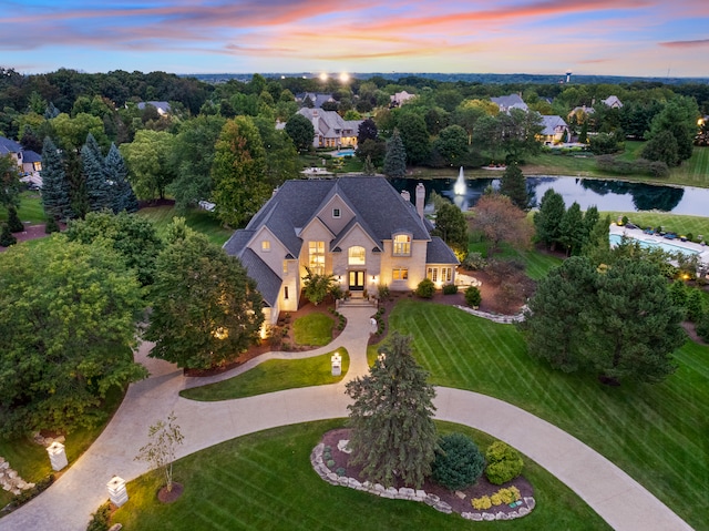 aerial view at dusk with a water view