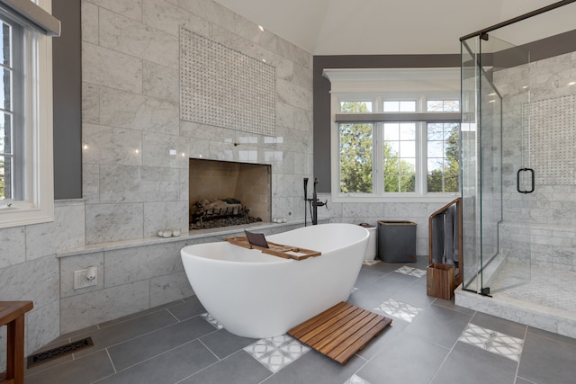 bathroom featuring tile walls, tile patterned floors, and plus walk in shower