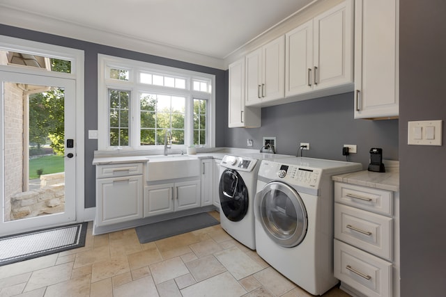 laundry area featuring separate washer and dryer, crown molding, cabinets, and sink