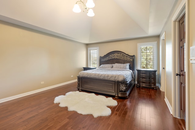 bedroom with multiple windows and dark hardwood / wood-style flooring