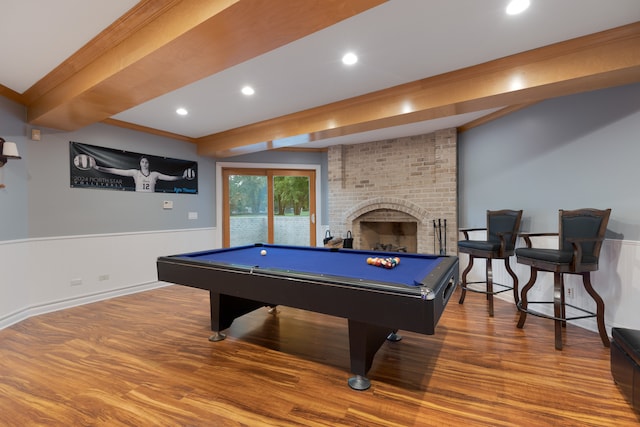 recreation room featuring billiards, a fireplace, crown molding, hardwood / wood-style floors, and beam ceiling