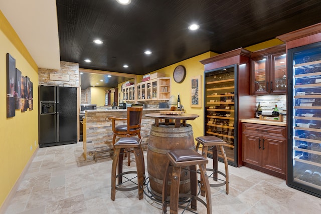 bar with wooden ceiling, backsplash, wine cooler, and black refrigerator with ice dispenser