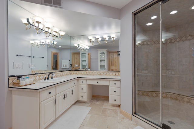 bathroom with vanity, walk in shower, and decorative backsplash