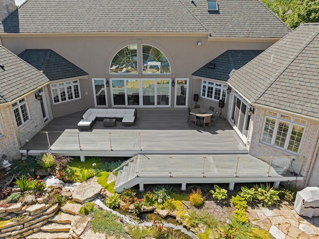 rear view of property with an outdoor hangout area and a wooden deck