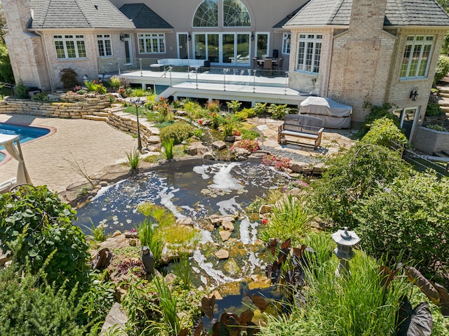 exterior space with a pool side deck and a patio area