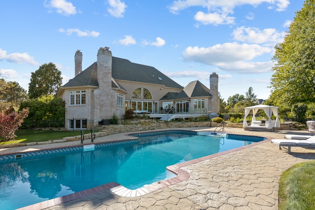 view of pool with a patio area and a gazebo