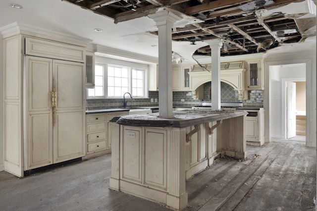 kitchen with tasteful backsplash, a center island, and cream cabinets