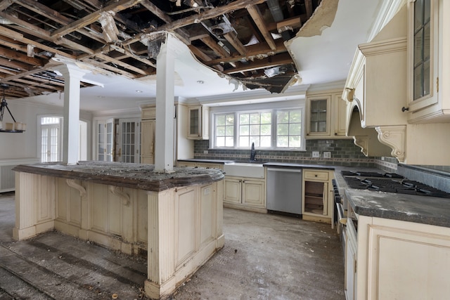 kitchen with sink, cream cabinetry, a kitchen island, tasteful backsplash, and stainless steel dishwasher