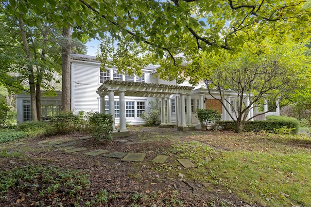 back of house with a pergola