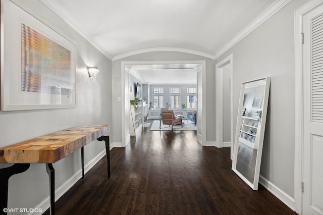 hallway featuring dark wood-type flooring, crown molding, and french doors