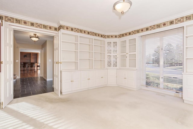 carpeted spare room with ornamental molding