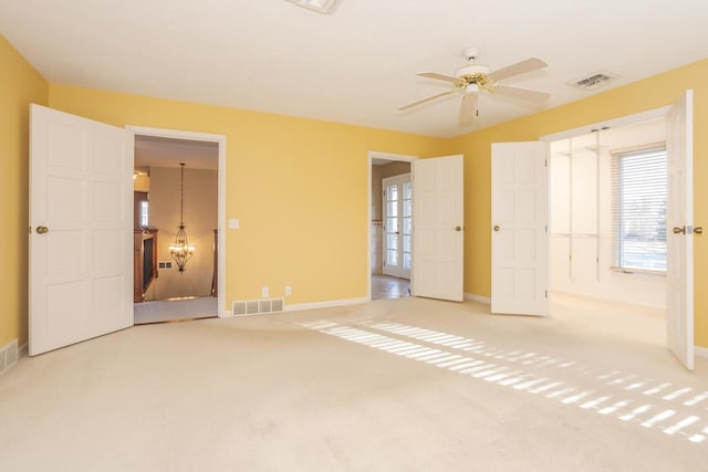 unfurnished bedroom featuring ceiling fan and light colored carpet