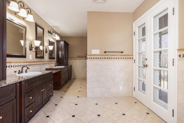 bathroom with tile patterned floors, vanity, and tile walls