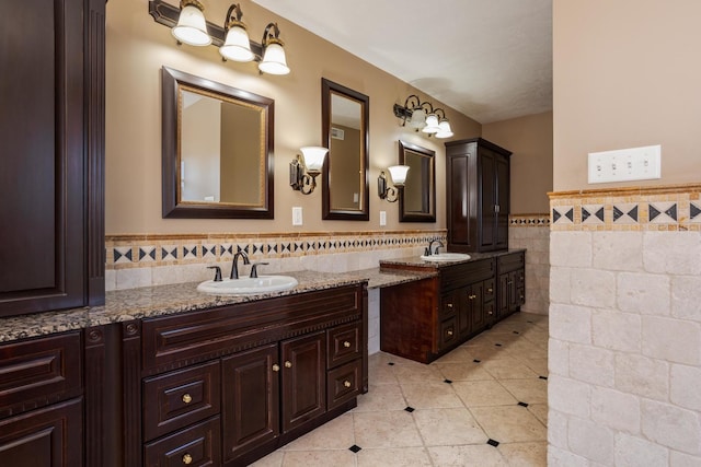 bathroom featuring tile patterned floors, vanity, and tile walls