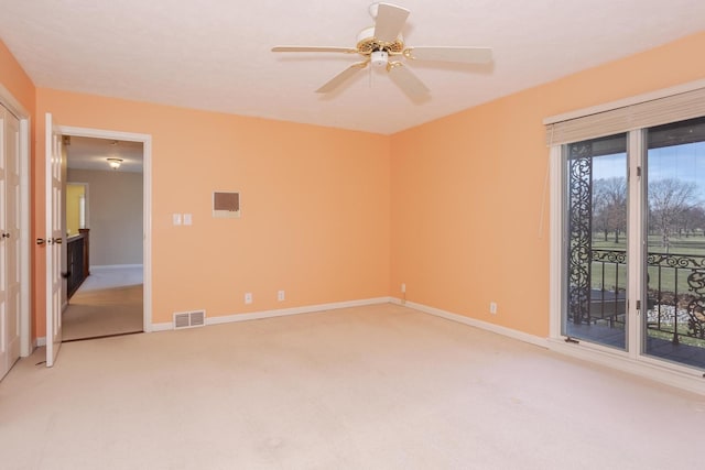 unfurnished room with visible vents, baseboards, light colored carpet, and ceiling fan