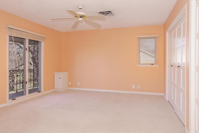 unfurnished bedroom featuring ceiling fan and light carpet