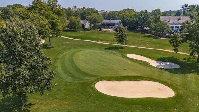 view of home's community with a lawn and golf course view