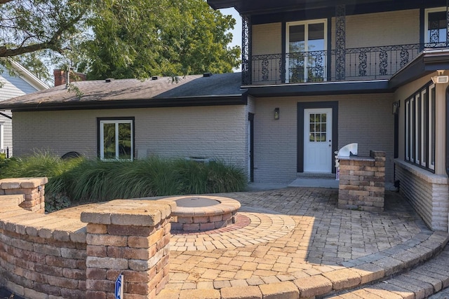 entrance to property featuring a patio area and a balcony