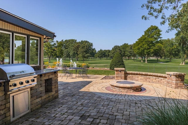 view of patio featuring a fire pit and area for grilling