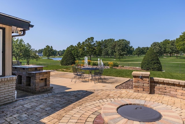 view of patio featuring fence and a water view