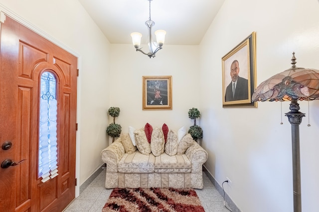 tiled foyer featuring an inviting chandelier