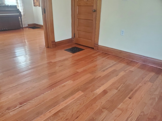 spare room featuring light wood-type flooring